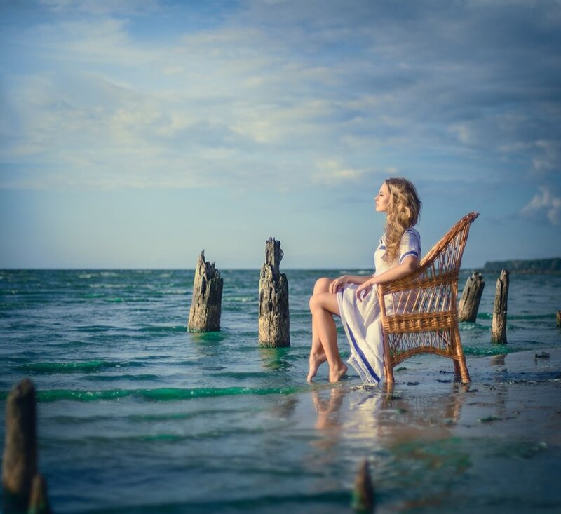 Woman Sitting in Wicker Chair — Blue