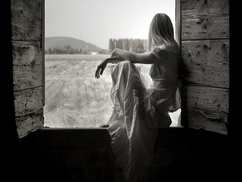 Woman Sitting in Window