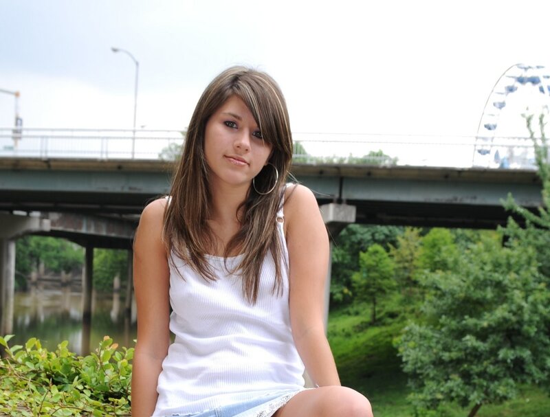 woman sitting near a bridge