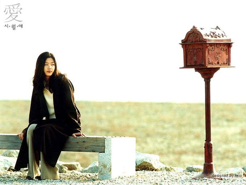 woman sitting near a mailbox