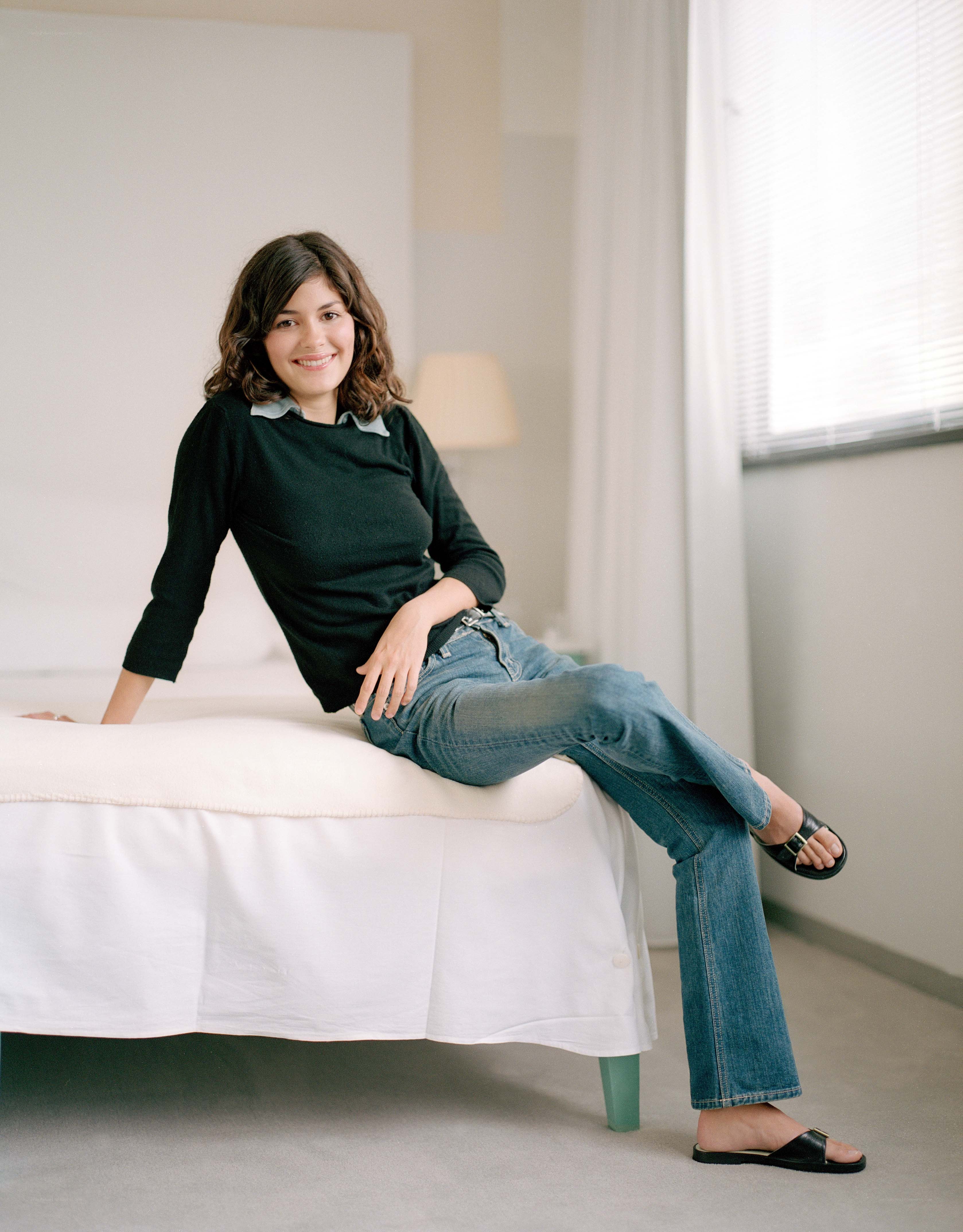 woman sitting on a bed