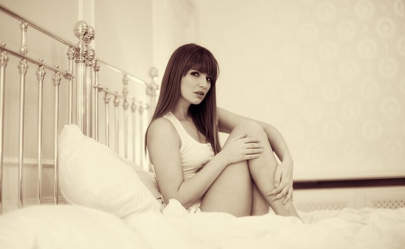 woman sitting on a bed