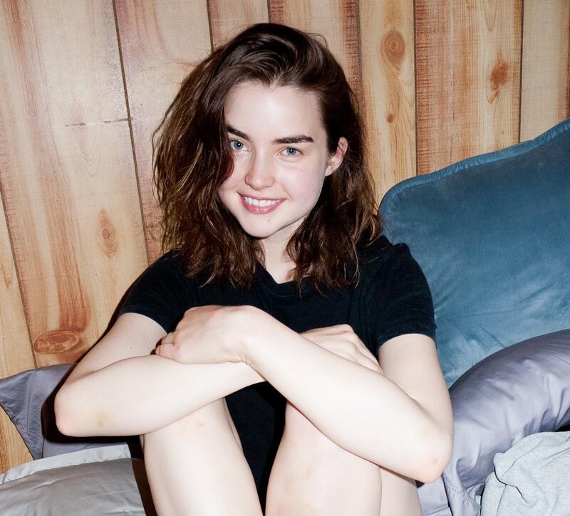woman sitting on a bed