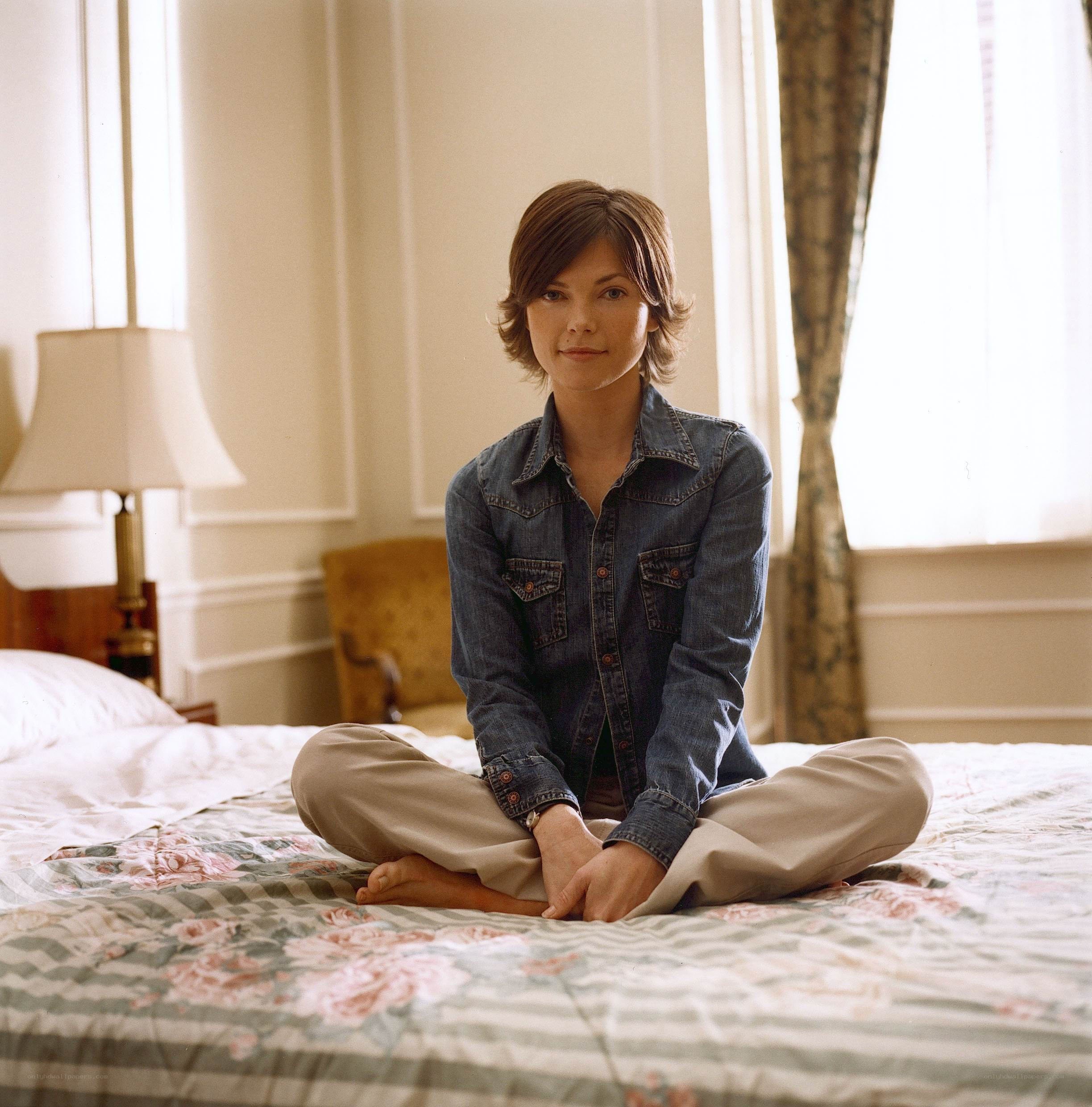 woman sitting on a bed