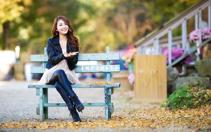 Woman sitting on a bench in autumn