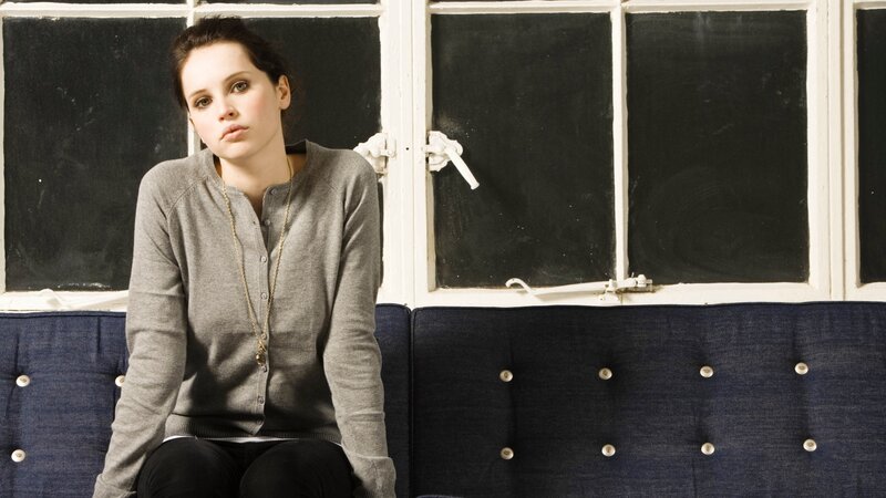 woman sitting on a blue couch