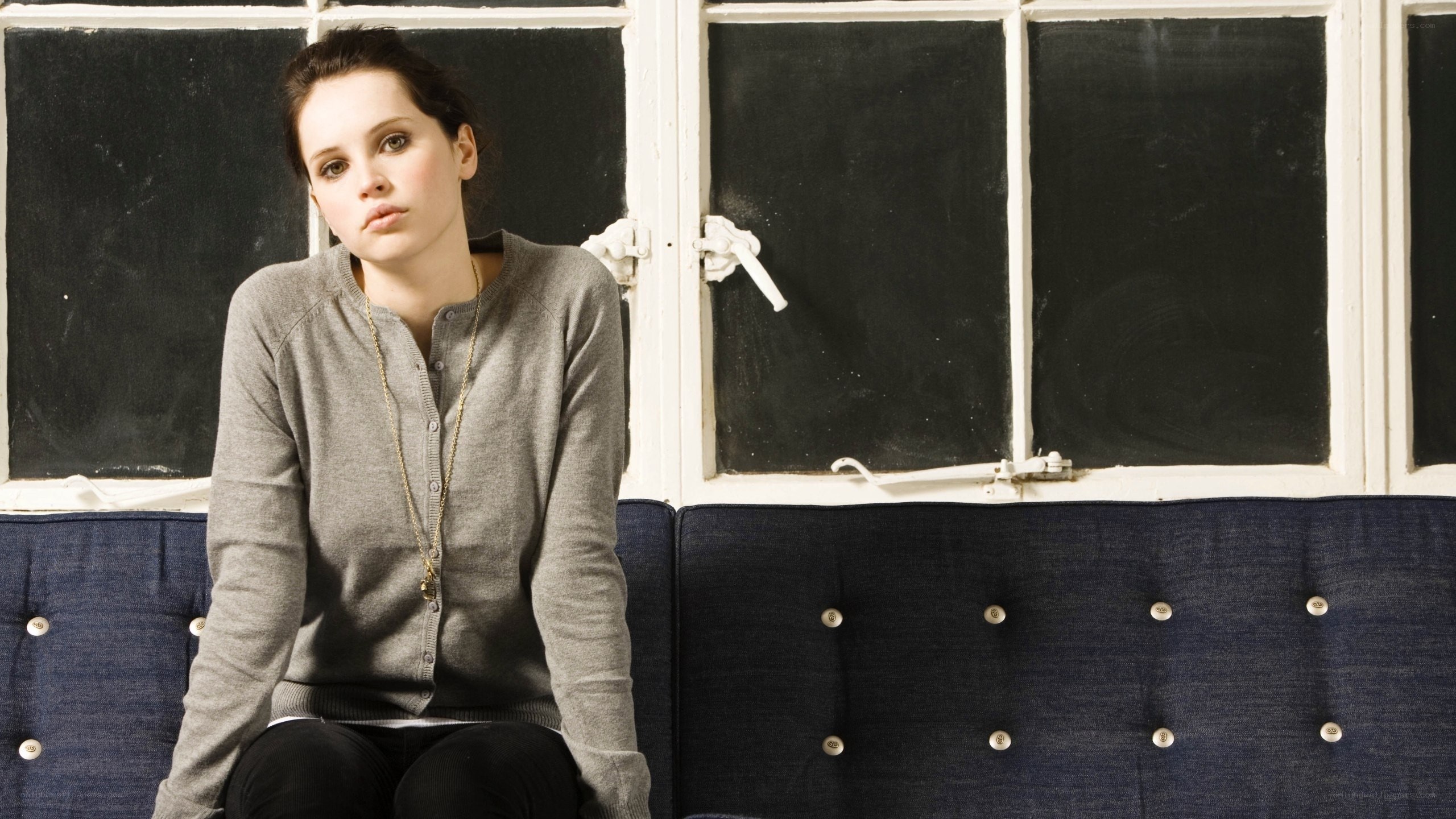 woman sitting on a blue couch