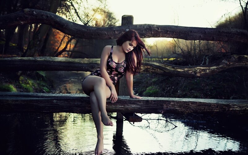 woman sitting on a bridge