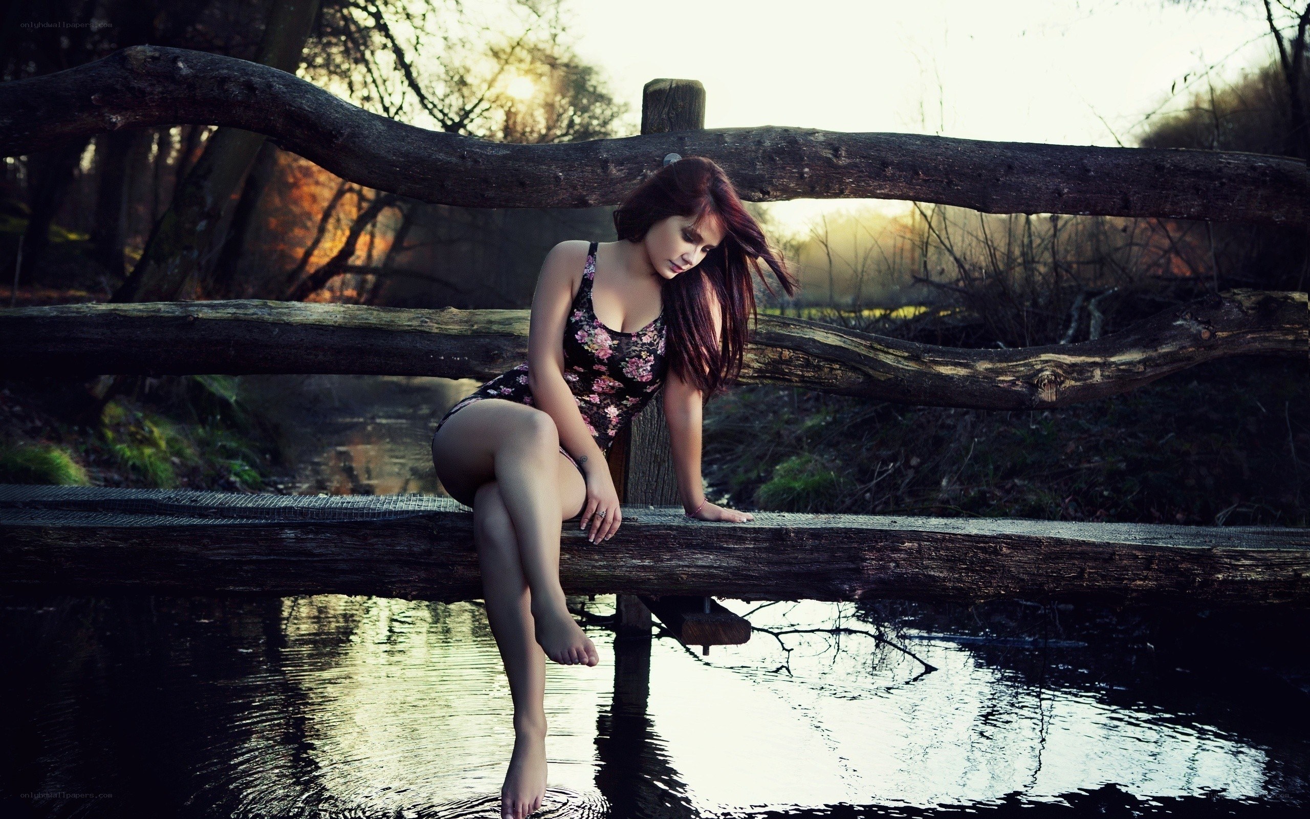 woman sitting on a bridge