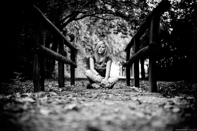 woman sitting on a bridge