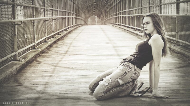 woman sitting on a bridge