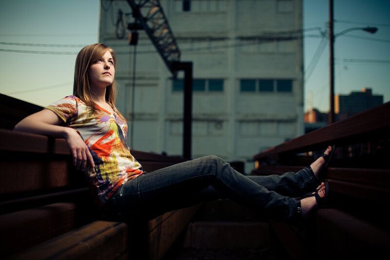 woman sitting on a bridge
