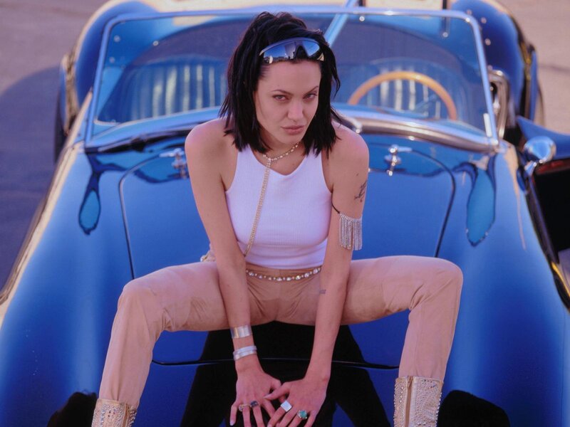 woman sitting on a car