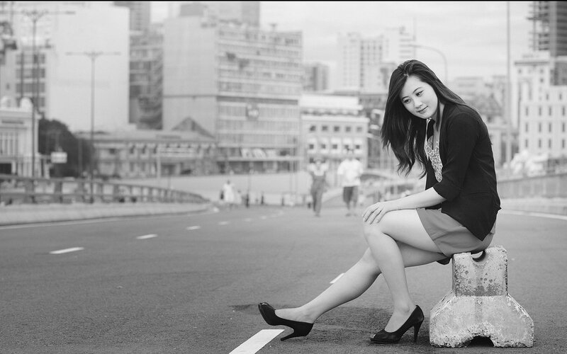 Woman sitting on a concrete block
