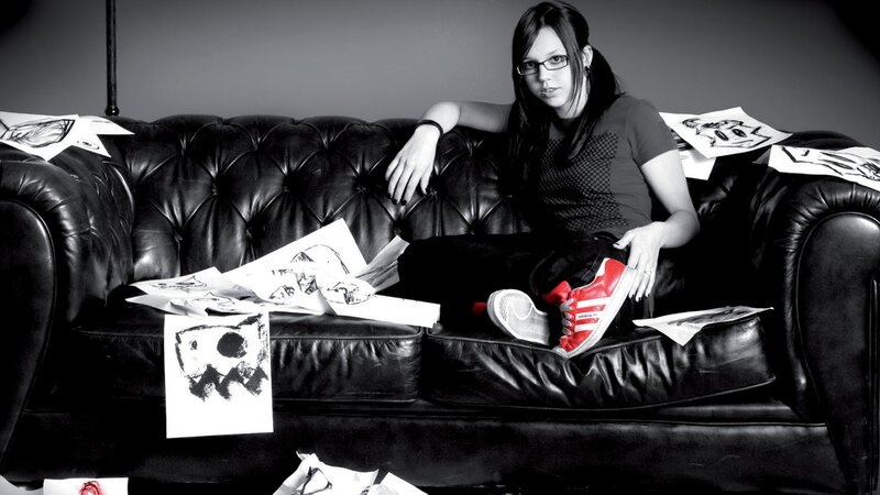 woman sitting on a couch with drawings