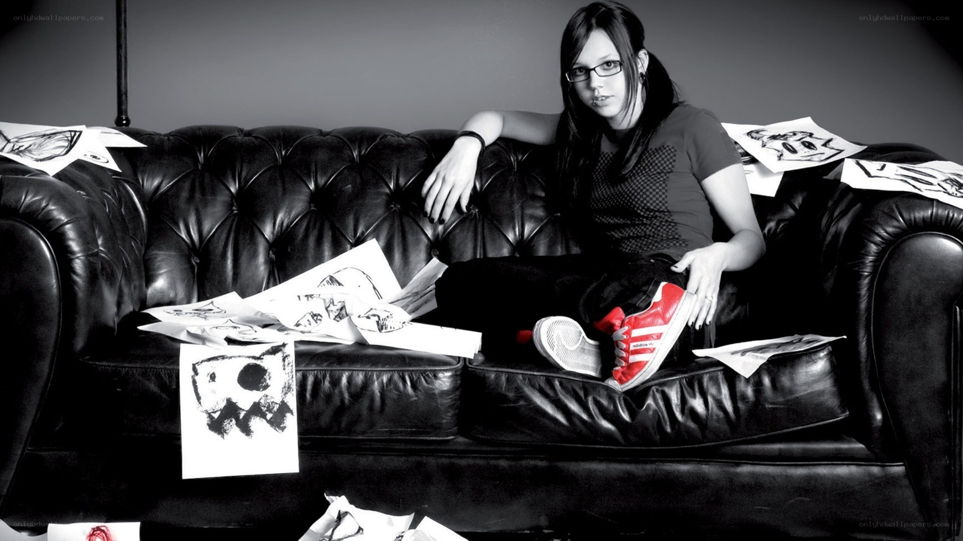 woman sitting on a couch with drawings