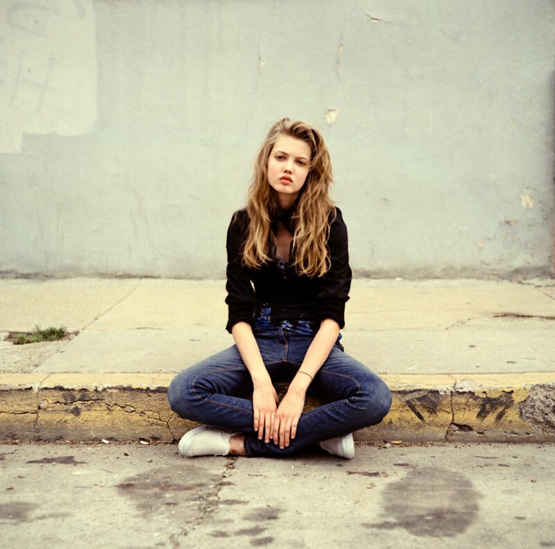 woman sitting on a curb