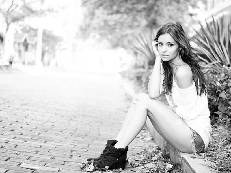 woman sitting on a curb