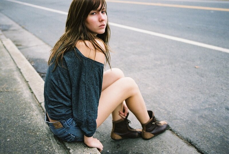 woman sitting on a curb