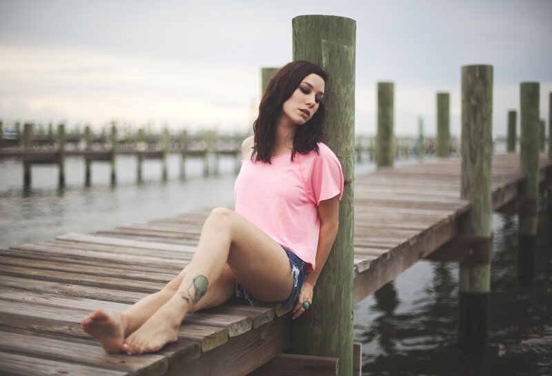 woman sitting on a dock