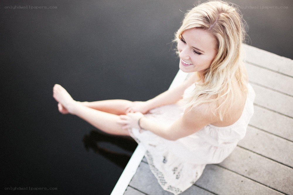 woman sitting on a dock