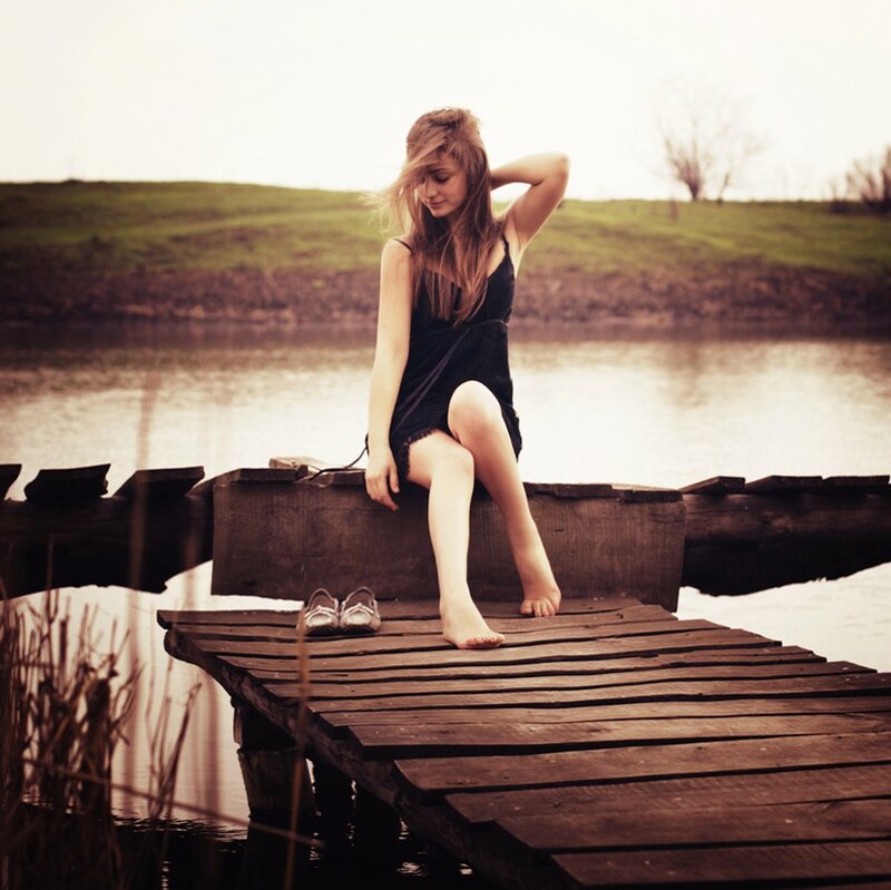 woman sitting on a dock