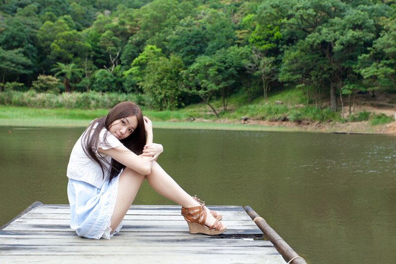 Woman sitting on a dock by the water
