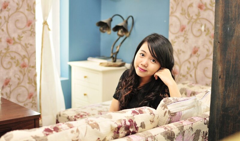 woman sitting on a floral couch