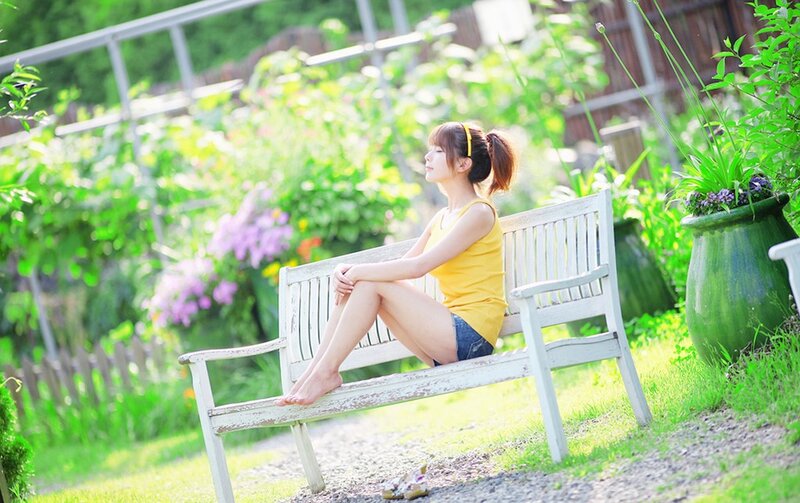 Woman sitting on a garden bench