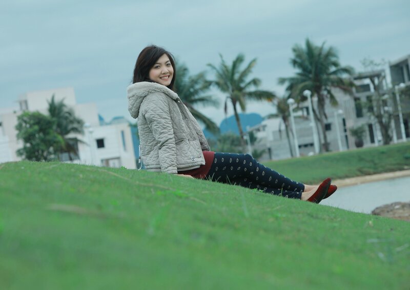 woman sitting on a grassy hill
