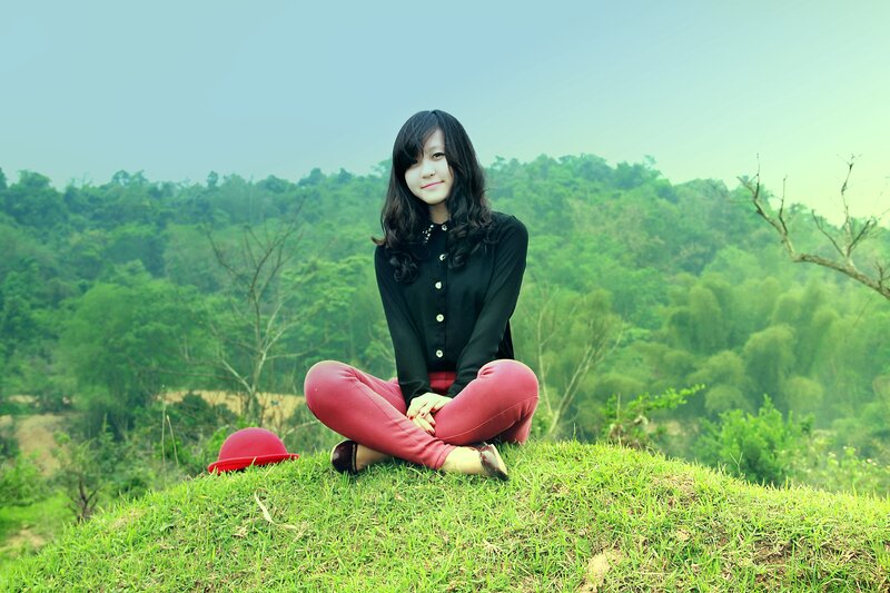 Woman sitting on a grassy hill