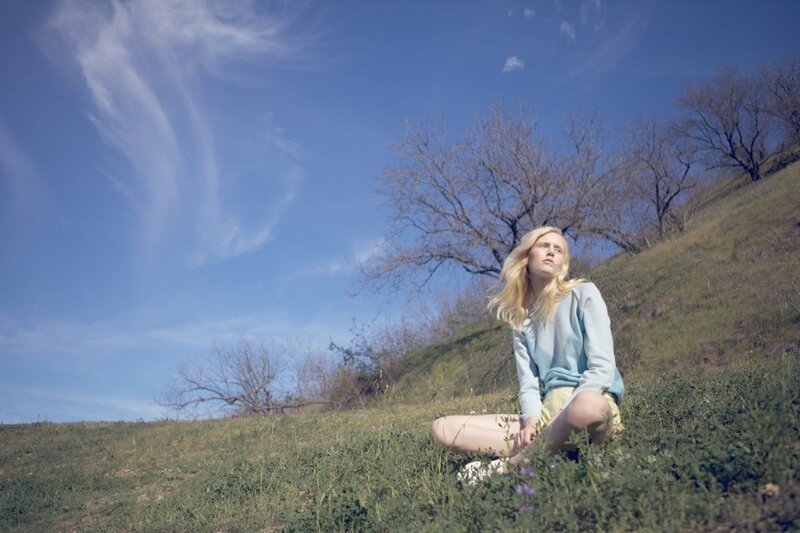 Woman sitting on a grassy hill