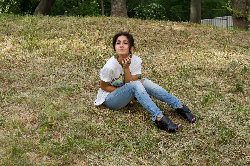 Woman sitting on a grassy hill