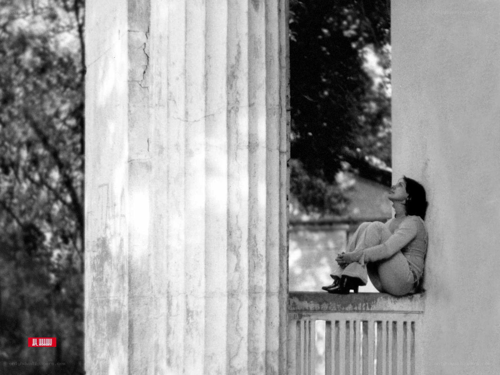woman sitting on a ledge