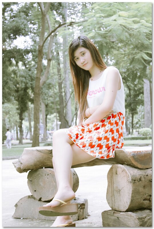 Woman sitting on a log bench