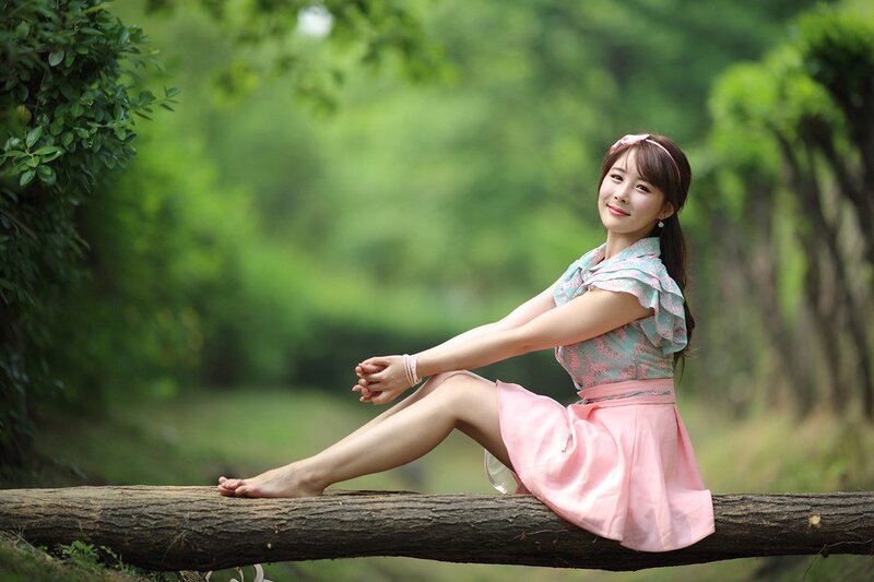 woman sitting on a log in nature