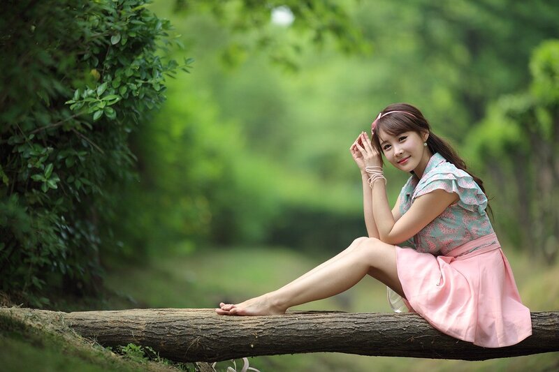 woman sitting on a log in nature