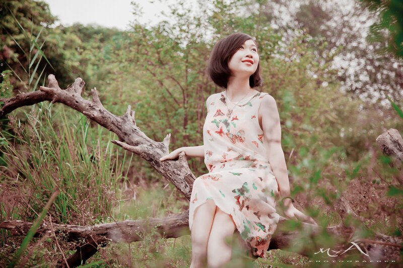 woman sitting on a log in nature