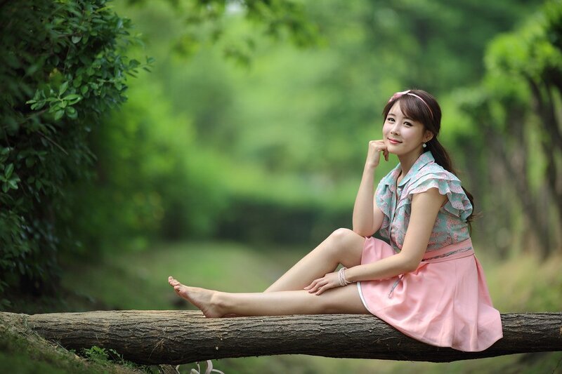 Woman sitting on a log in the forest
