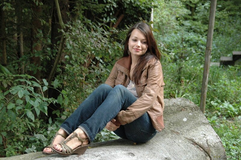 Woman sitting on a log in the woods
