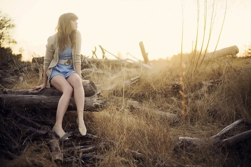 Woman sitting on a log