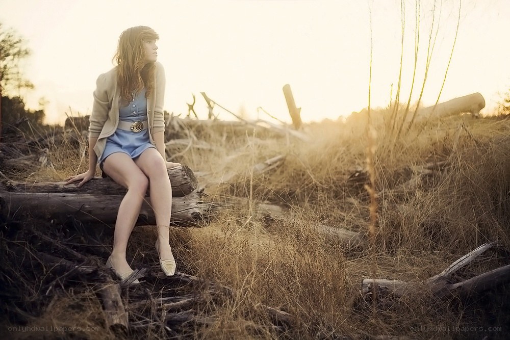 Woman sitting on a log