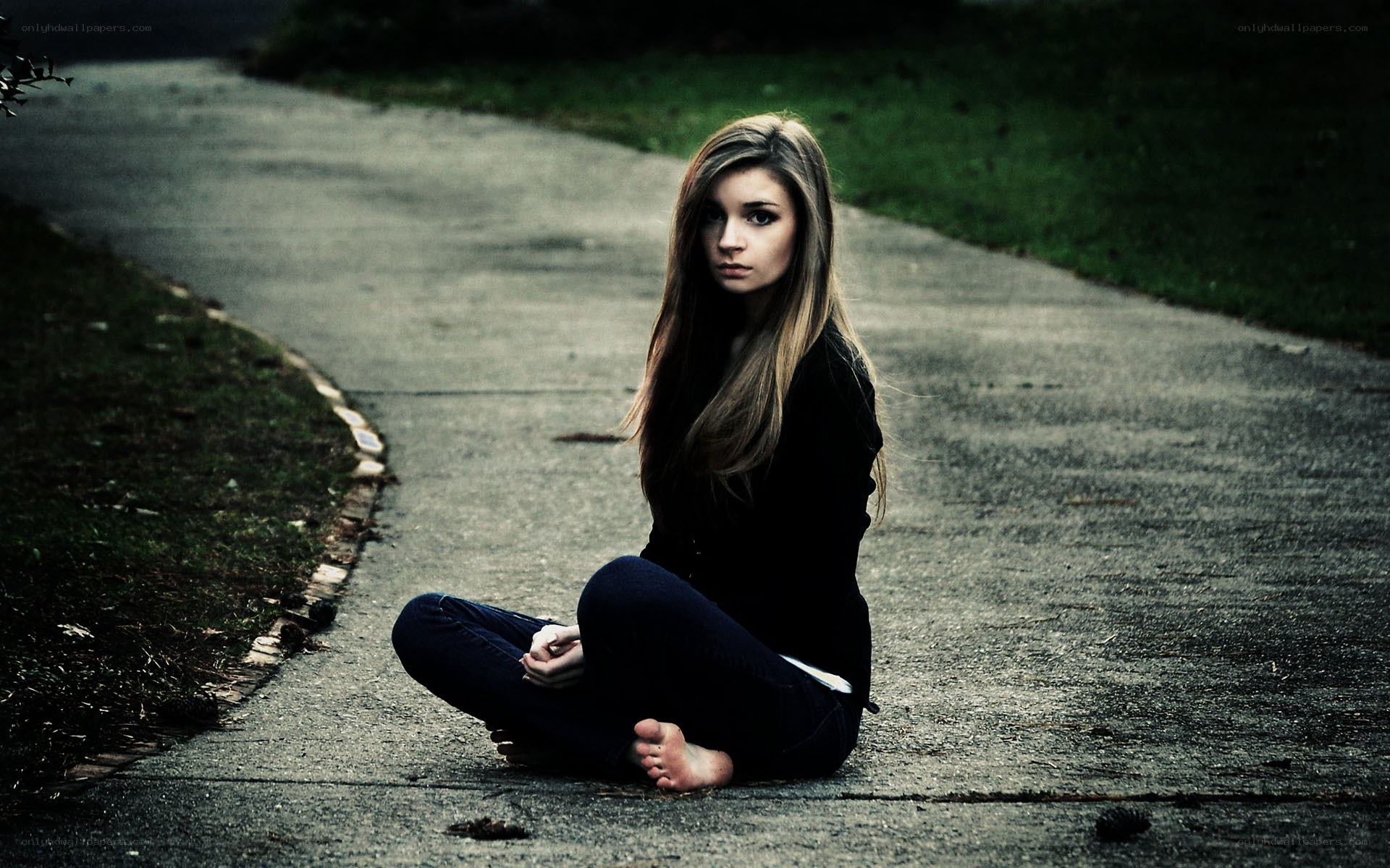 woman sitting on a path