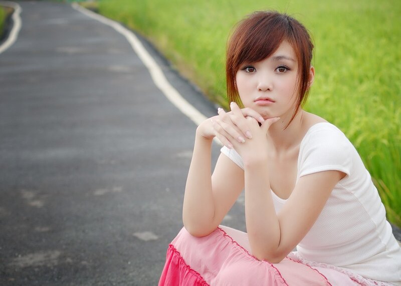 woman sitting on a road