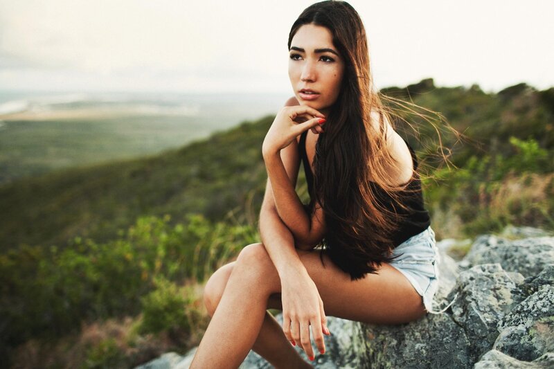woman sitting on a rock