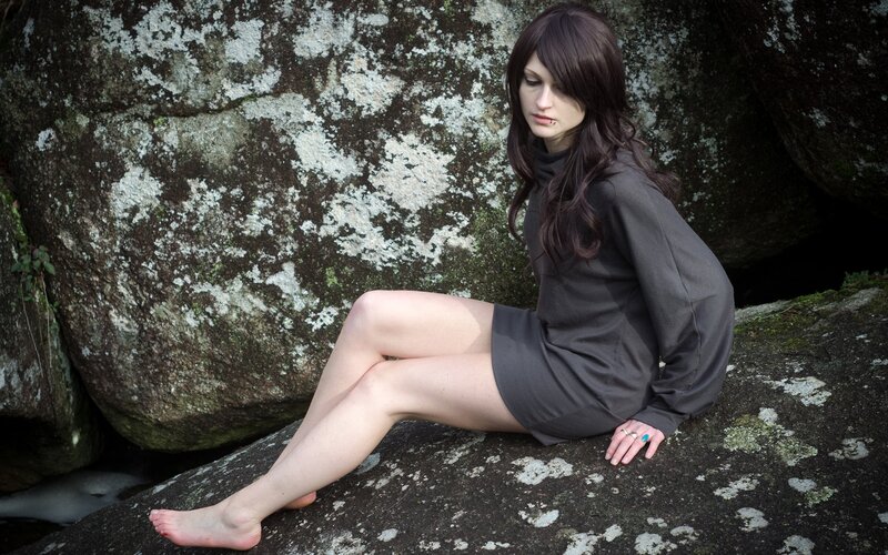 Woman sitting on a rock