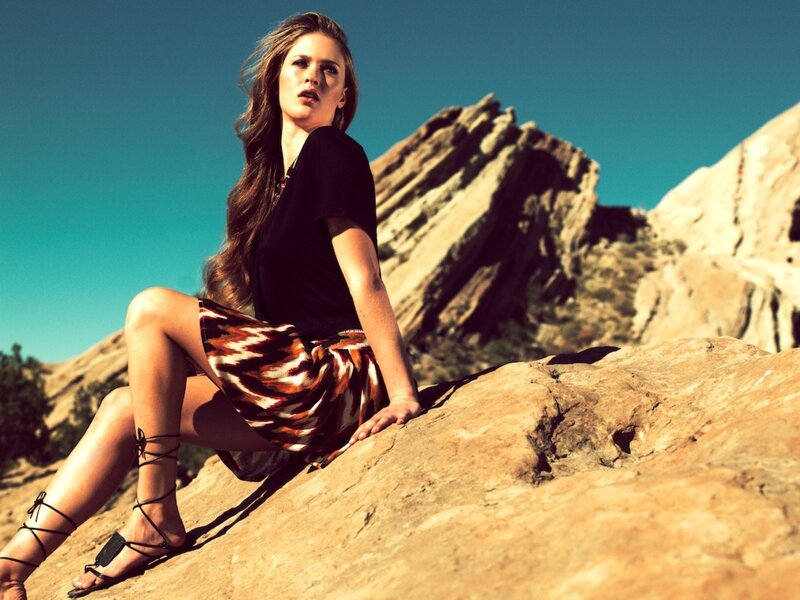Woman sitting on a rock