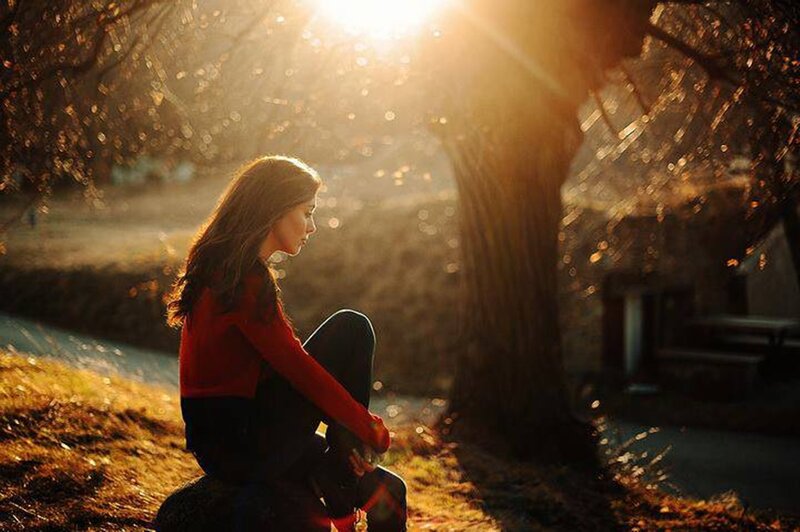 Woman Sitting on a Rock — Red