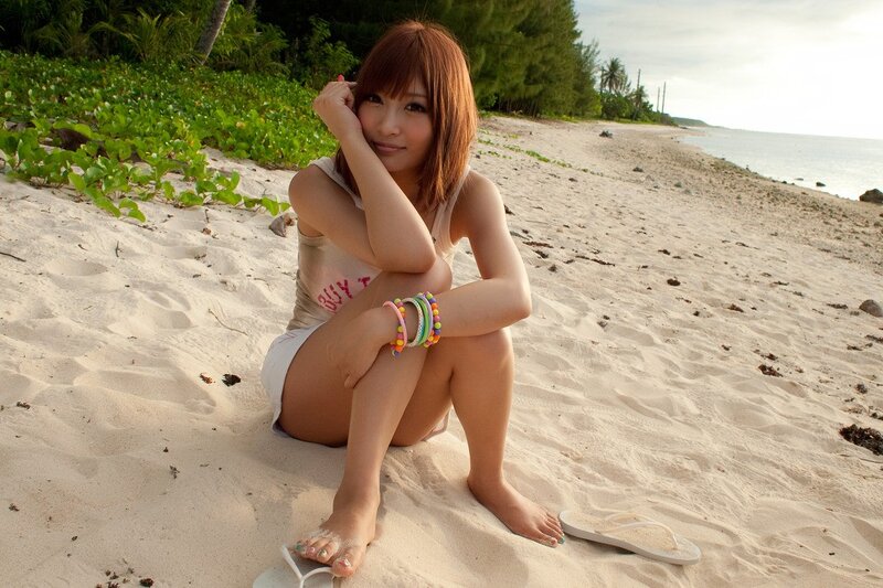 Woman sitting on a sandy beach