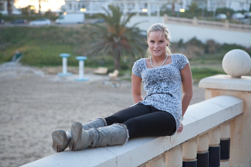 Woman sitting on a seaside wall